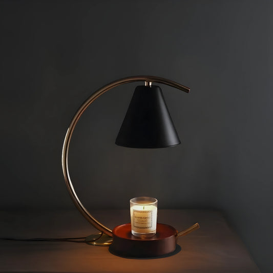 View of a sculptural dimmable candle warmer table lamp featuring a textured ceramic base in earthy tones and a sleek, modern design