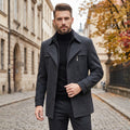 A model showcases a mens tailored winter coat in a sleek navy color, paired with accessories against a minimalist backdrop.