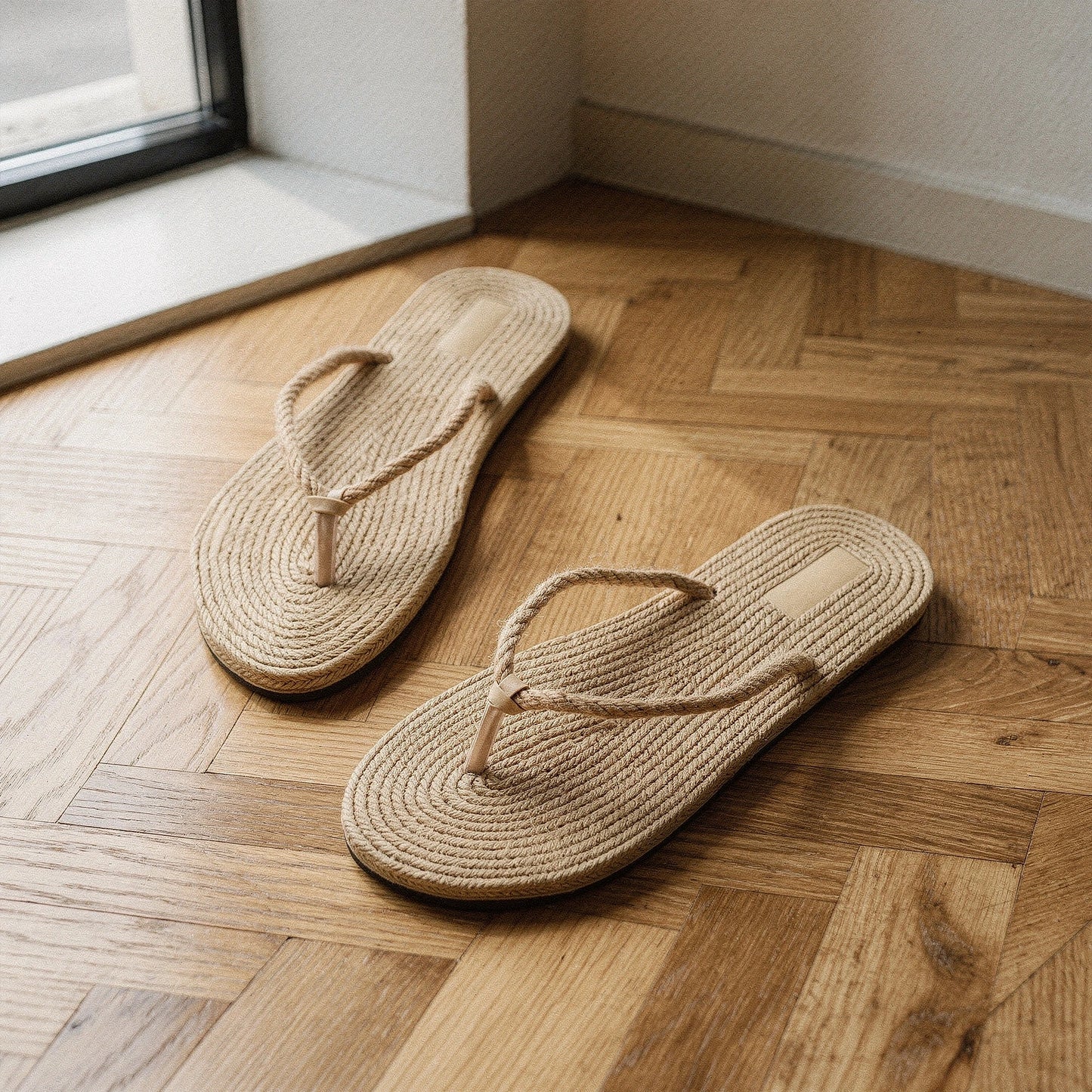 View of chic casual straw flip flop sandals in natural beige, featuring a woven straw upper and comfortable footbed