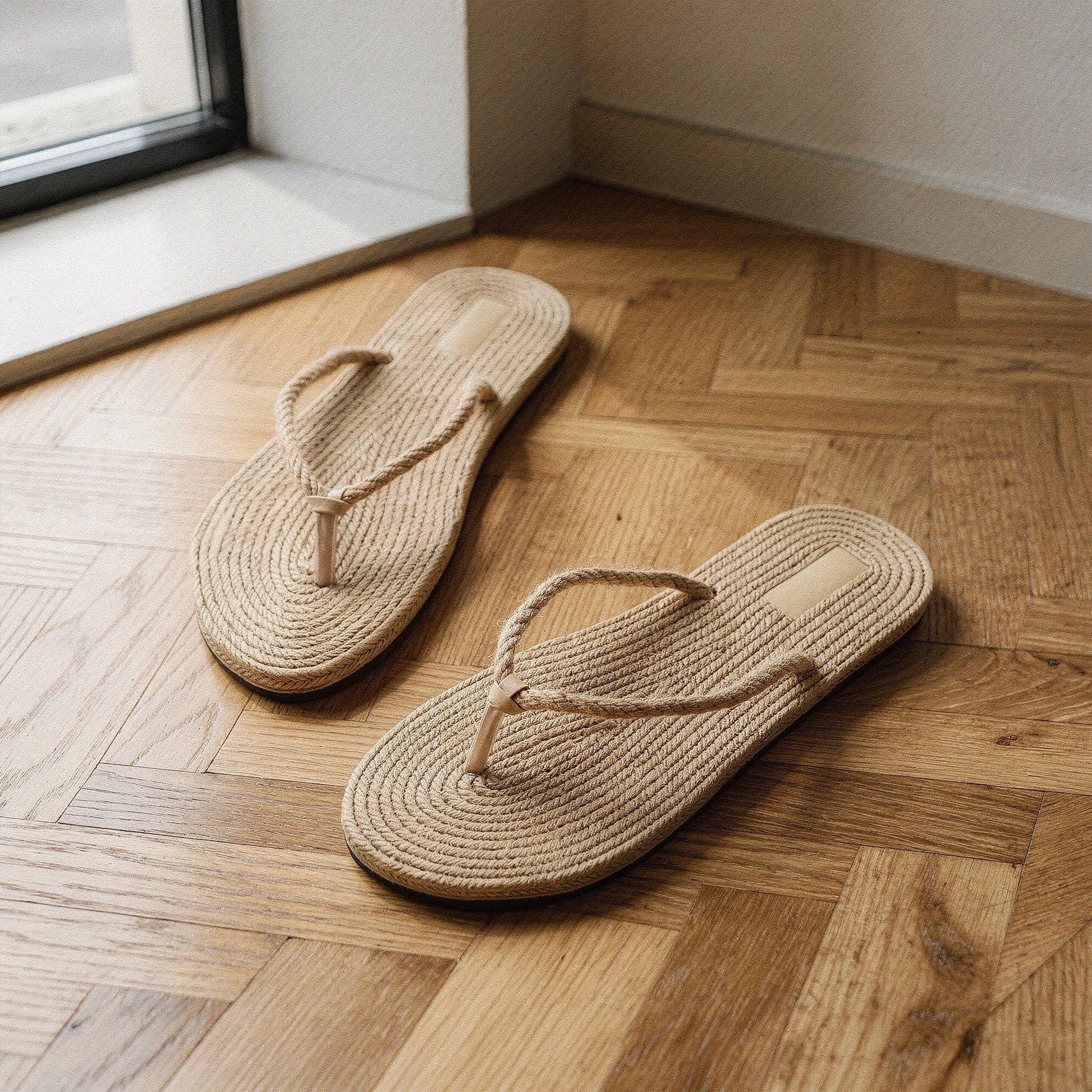 View of chic casual straw flip flop sandals in natural beige, featuring a woven straw upper and comfortable footbed
