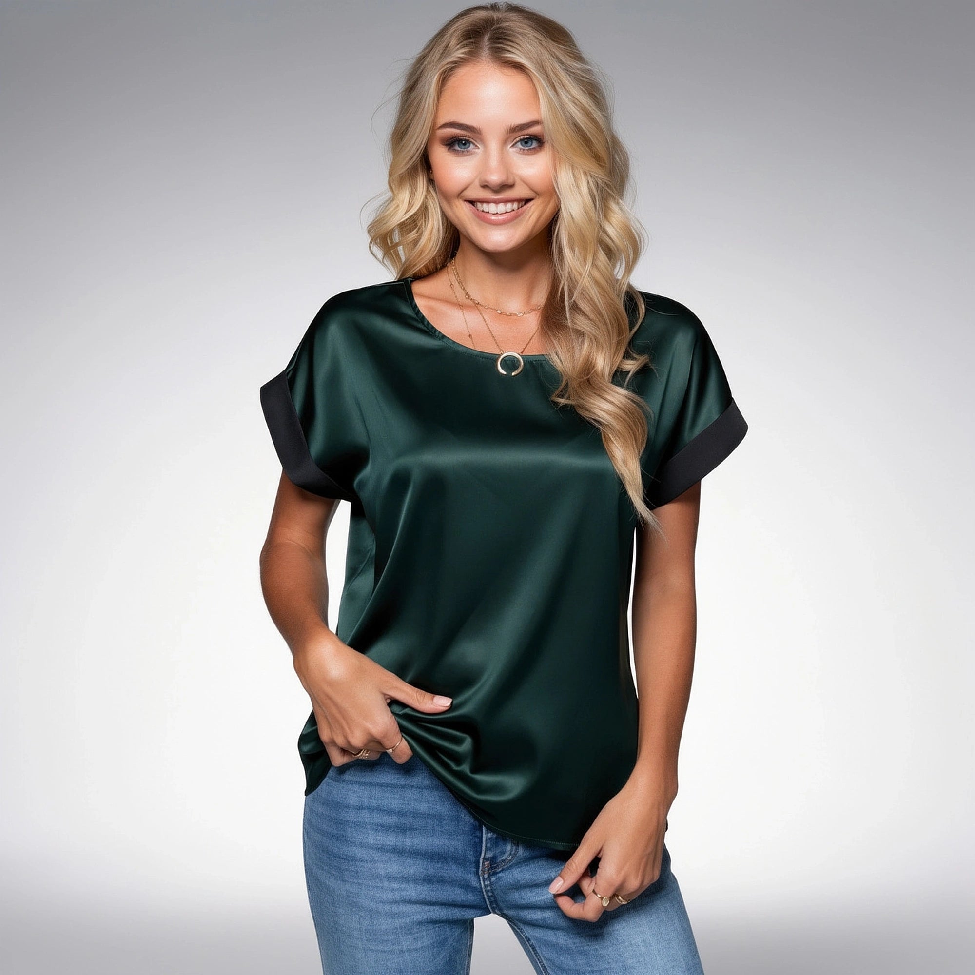 View of a relaxed satin blouse in soft ivory, featuring a delicate drape and subtle sheen