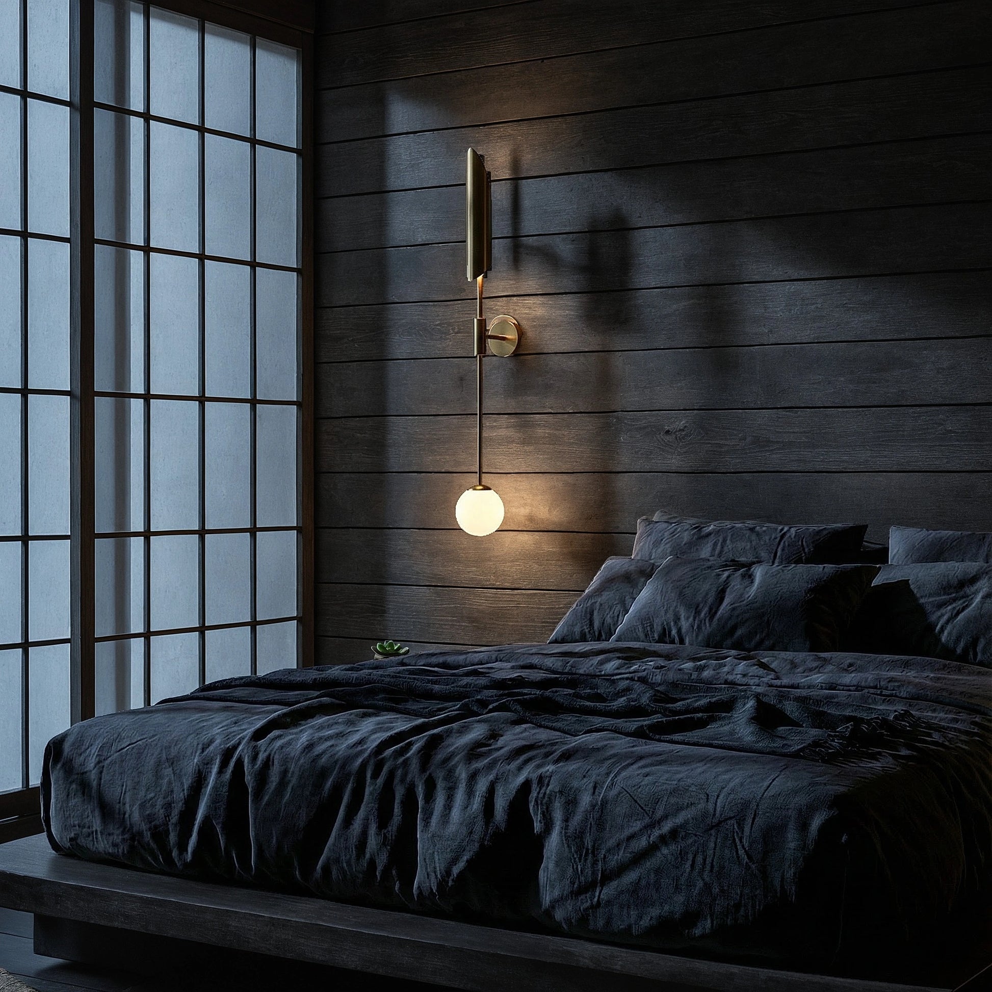 View of a brass wall sconce featuring dual light bulbs and a refined Nordic design, highlighting its elegant curves and warm finish
