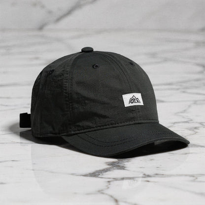 View of a stylish men's baseball cap in dark gray, made from breathable fabric, featuring a curved brim and adjustable strap