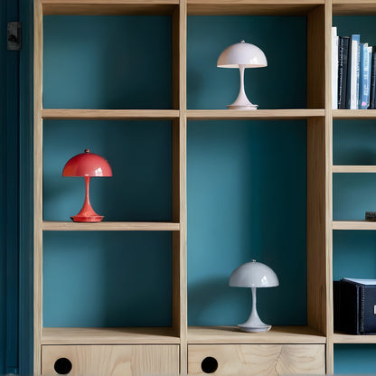 View of a sleek contemporary rechargeable table lamp in a warm brass finish, showcasing a minimalist design with a fabric shade