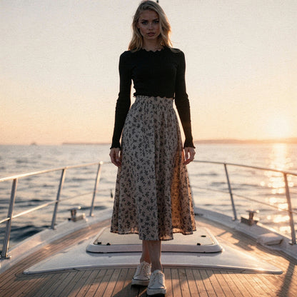 View of a flowy spring midi skirt in soft pastel colors, featuring a lightweight fabric and delicate floral patterns