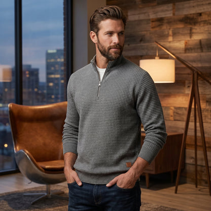 Close up view of the Mens Refined Quarter Zip Sweater showing its soft fabric, precise stitching, and design details against a neutral background.