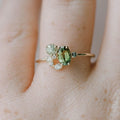 View of an elegant women's ring featuring a delicate design with a vibrant peridot stone set in polished metal