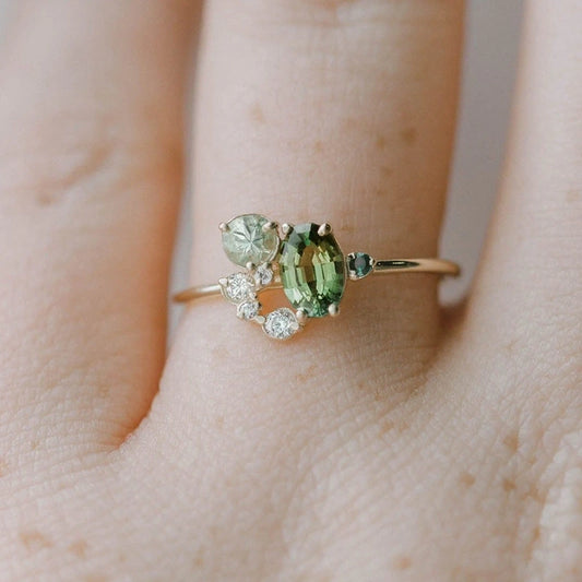 View of an elegant women's ring featuring a delicate design with a vibrant peridot stone set in polished metal