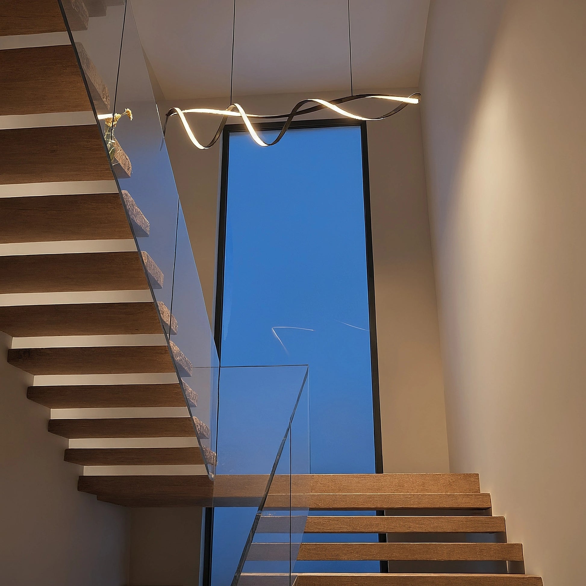 Close up view showing the wave inspired design and intricate details of the Sculptural LED Overhead Light Fixture against a white background.