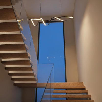 Close up view showing the wave inspired design and intricate details of the Sculptural LED Overhead Light Fixture against a white background.