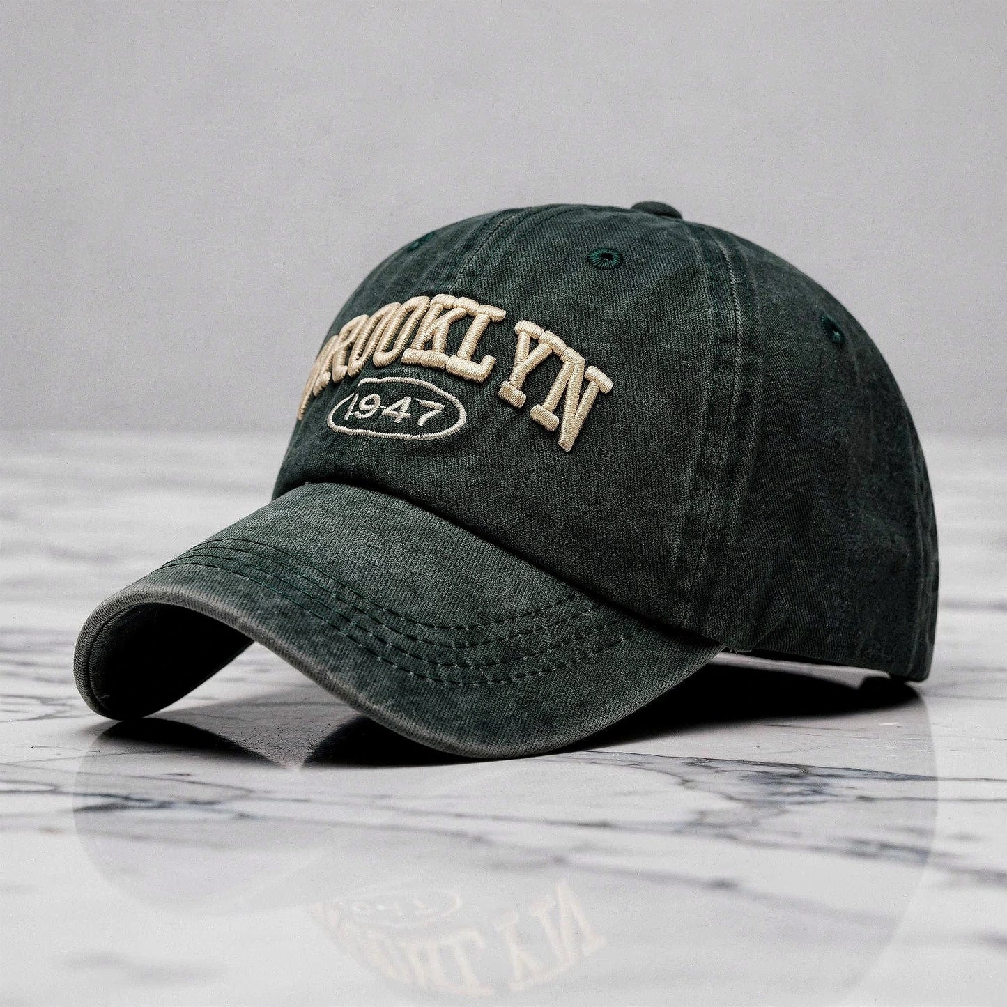 View of a casual chic embroidered cap in light gray, featuring intricate stitching and a curved brim
