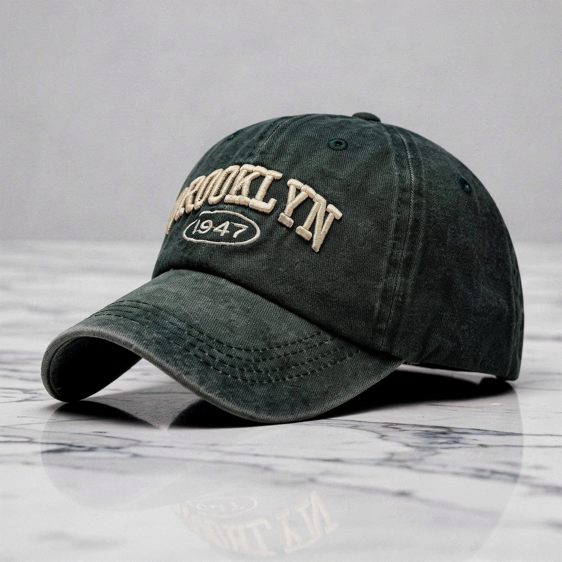 View of a casual chic embroidered cap in light gray, featuring intricate stitching and a curved brim