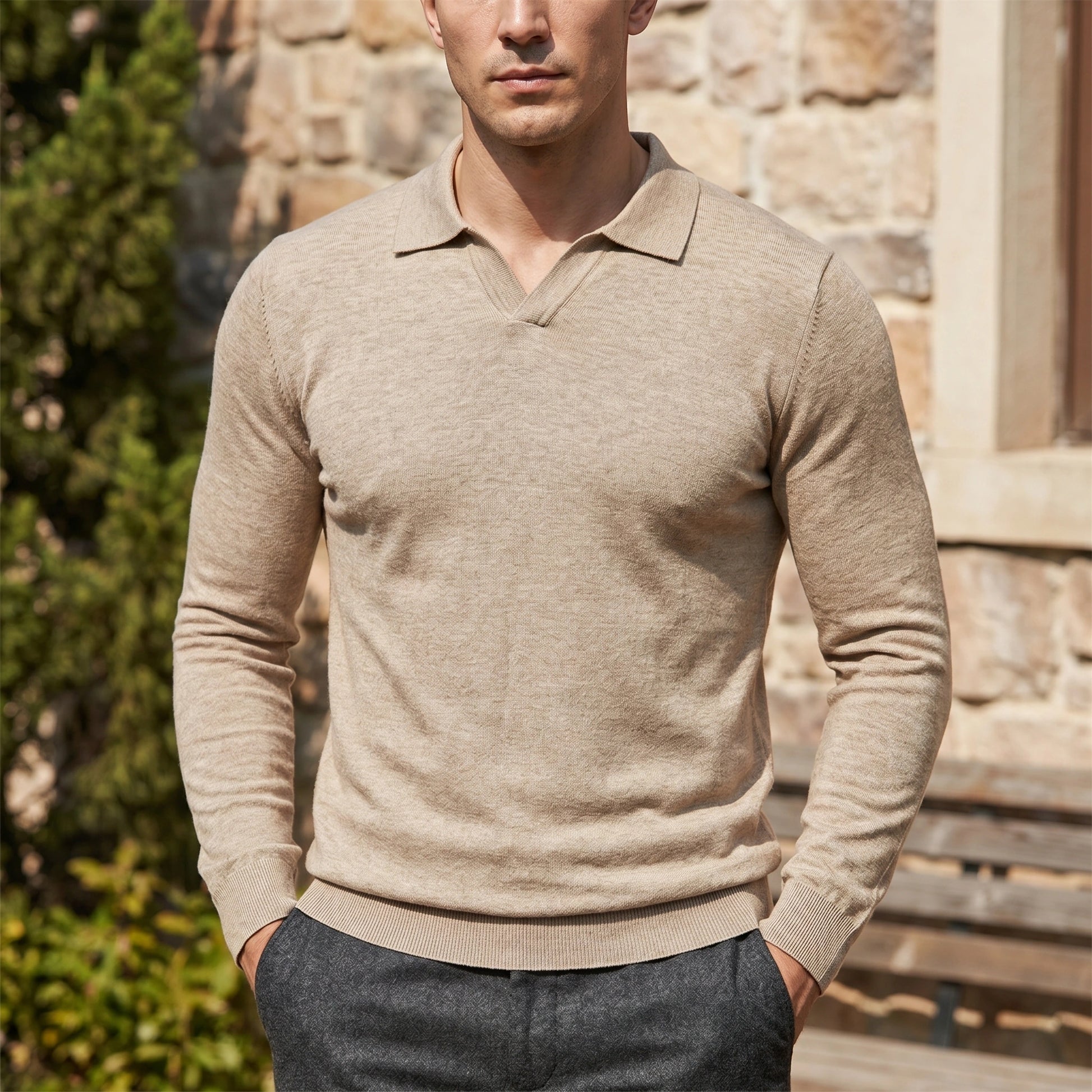 Back view of a model wearing a mens sophisticated long sleeve polo sweater in a rich navy color, showing its fine knit construction and tailored fit against a neutral backdrop.