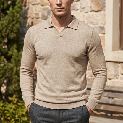 Back view of a model wearing a mens sophisticated long sleeve polo sweater in a rich navy color, showing its fine knit construction and tailored fit against a neutral backdrop.