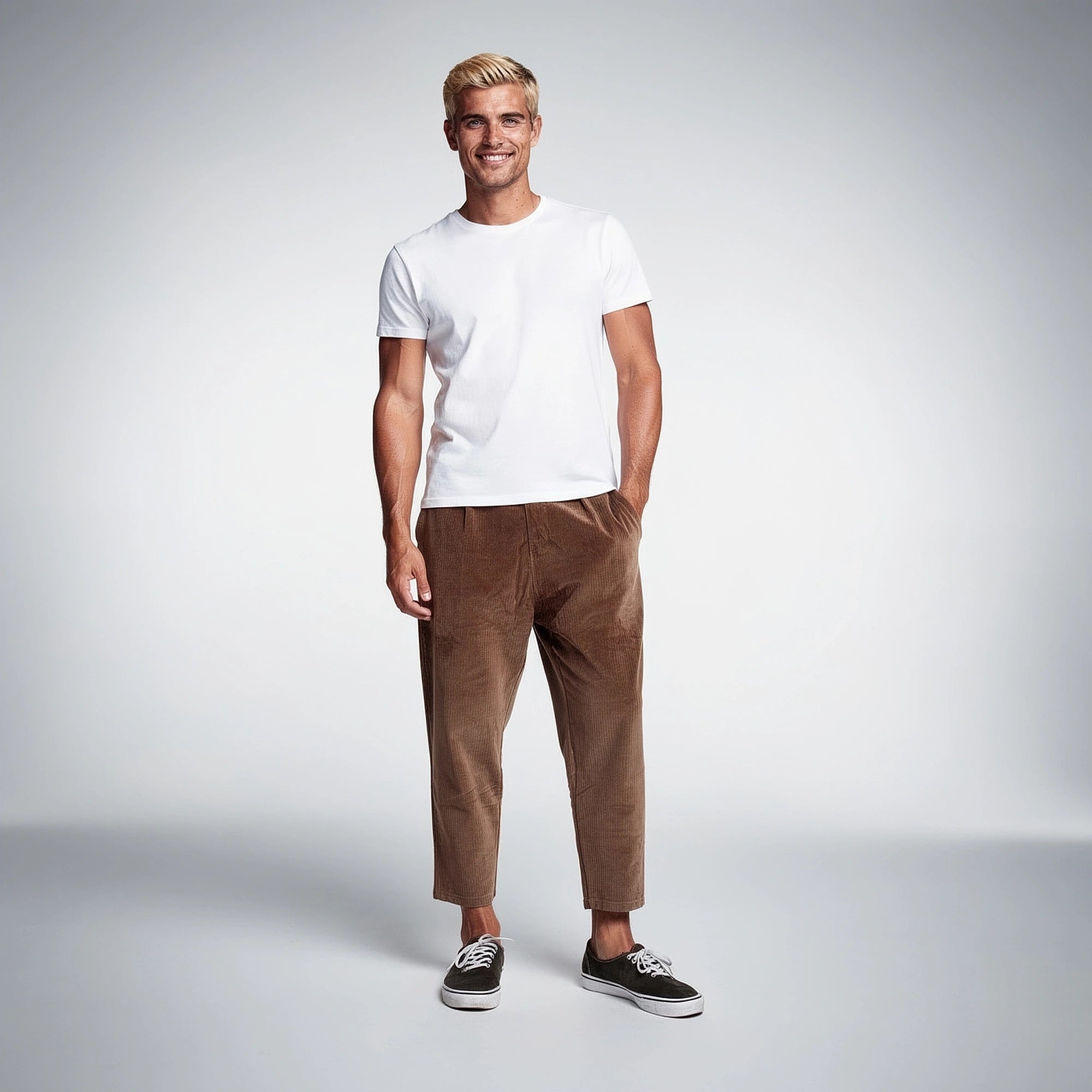 View of relaxed fit corduroy trousers in a warm tan color, featuring a comfortable waistband and pockets