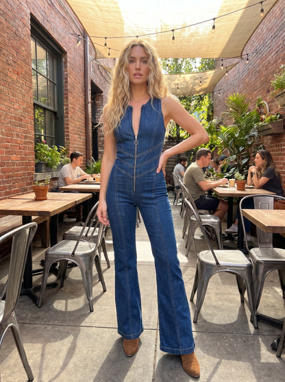 A model showcases a playful backless denim jumpsuit in a vibrant summer setting, showing its 78 length length design and perfect fit for festivals.
