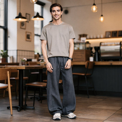 Lightweight summer trousers in light gray, featuring a relaxed fit and pockets, shown in a view