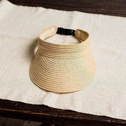 Light beige summer visor hat with a wide brim and stylish woven texture, detailed view showcasing the fabric and design