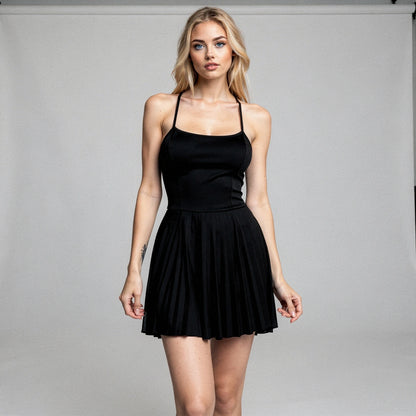View of an elegant pleated mini dress in soft pink fabric, featuring a fitted bodice and flowing skirt
