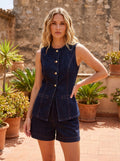 Back view of a model wearing a women's sleeveless indigo denim top with mock pockets, showing the construction details against a neutral background.