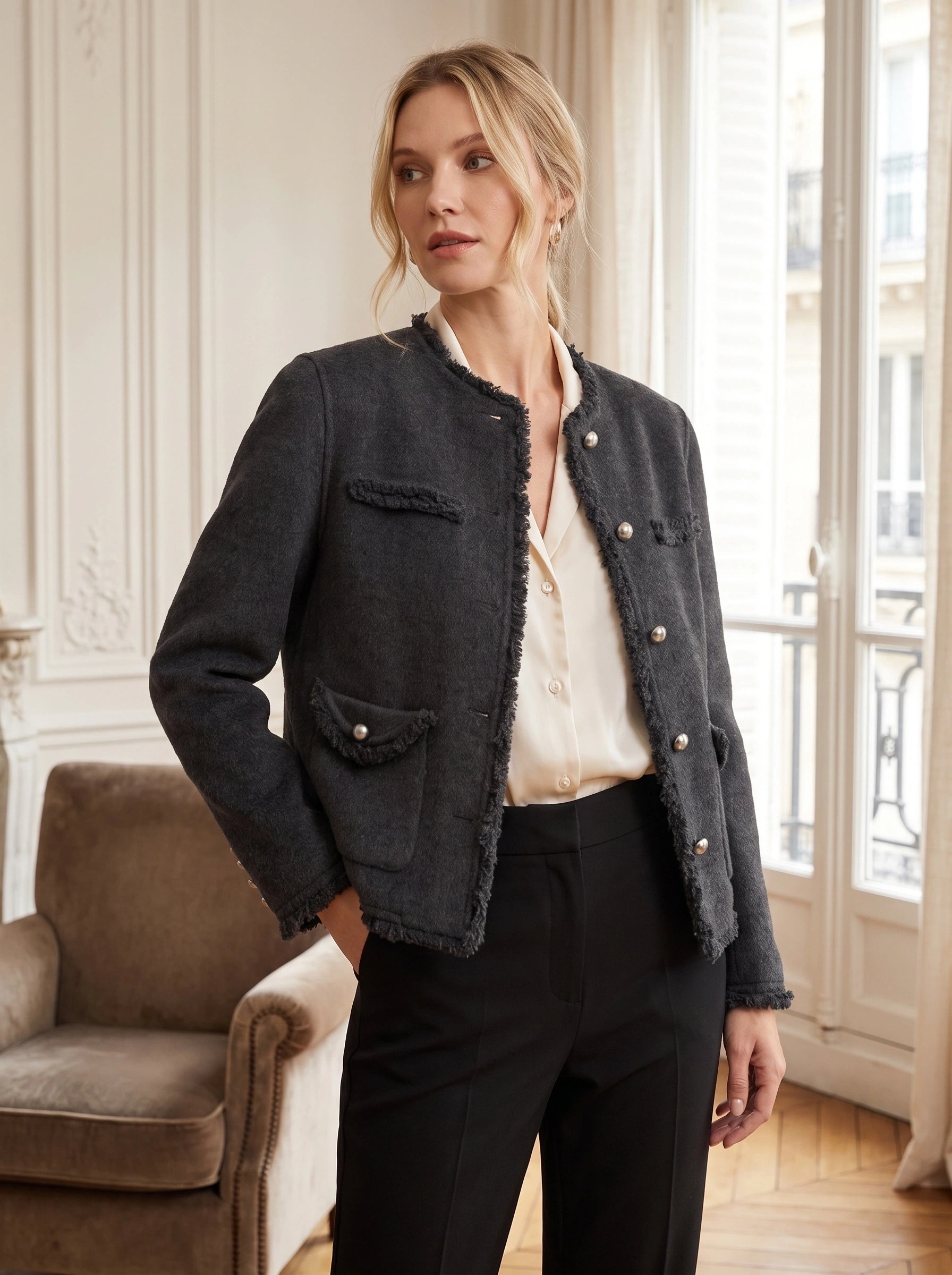 Close up view of the women's tailored autumn jacket showing frayed edges, intricate stitching, and rich fabric texture against a neutral background.