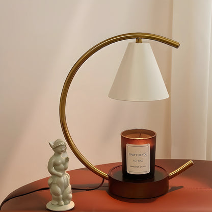 View of a sculptural dimmable candle warmer table lamp in a soft beige finish, featuring a unique textured design