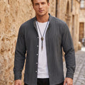 Back view of a model wearing a mens textured relaxed spring shirt in a soft pastel color, showing the shirt's construction details and casual style.