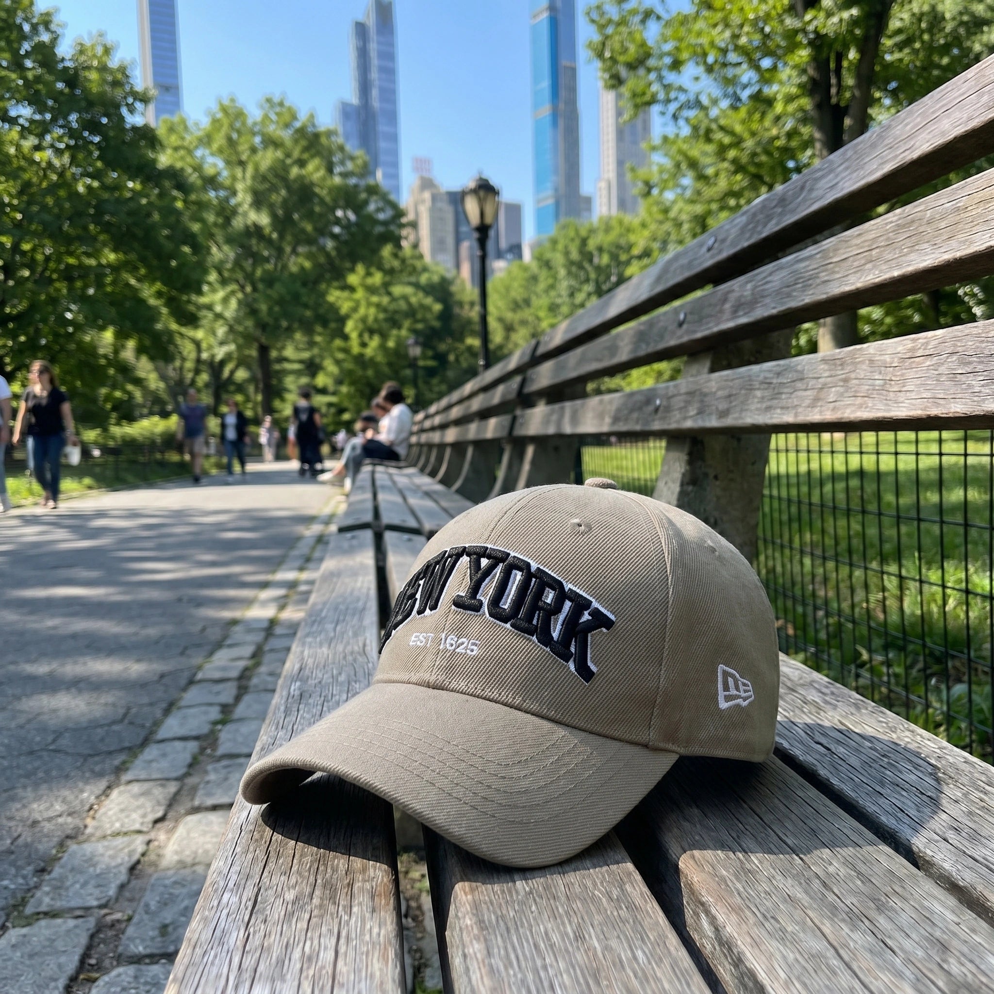 A model showcases the adjustable polyester baseball cap in a casual outdoor outfit, showing a colorful palette against a natural background.