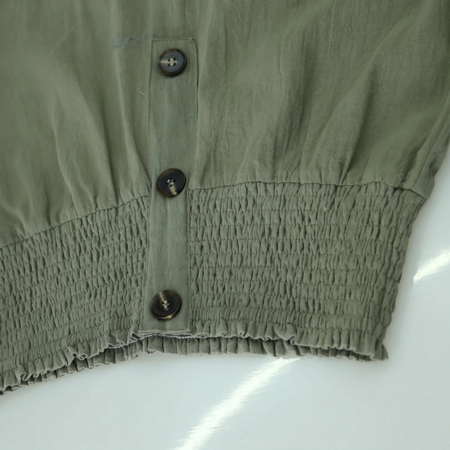 Close up of the Womens Effortless Summer Trousers showing the lightweight fabric, refined stitching, and high waisted design in a soft pastel hue.