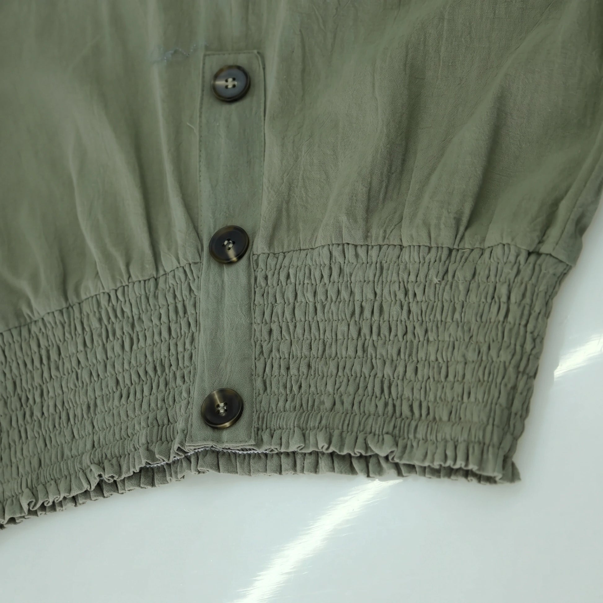 Close up of the Womens Effortless Summer Trousers showing the lightweight fabric, refined stitching, and high waisted design in a soft pastel hue.