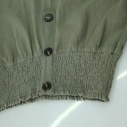 Close up of the Womens Effortless Summer Trousers showing the lightweight fabric, refined stitching, and high waisted design in a soft pastel hue.