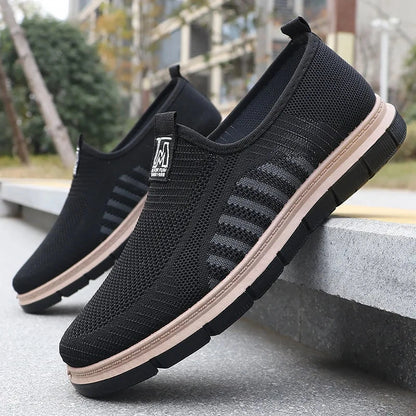 View of stylish men's casual shoes featuring a knit upper in a light gray color with a textured finish
