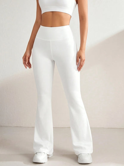 Back view of a model wearing high waisted women's slim flattering casual trousers in a versatile neutral color, showing the construction details against a minimalist background.