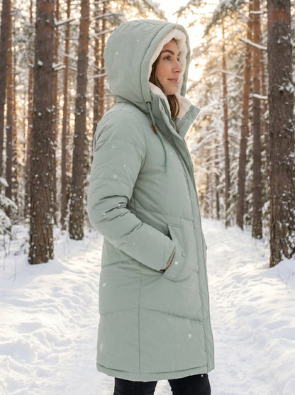 Close up view of the women's flattering quilted winter puffer jacket showing the intricate stitching and luxurious fabric texture against a neutral background.