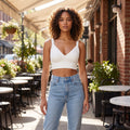 Close up view of the Womens Supportive Cropped Top showing its soft fabric, intricate stitching, and design details against a neutral background.