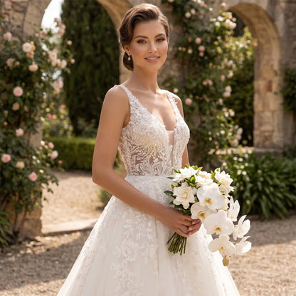 A model showcases the Womens Boho Wedding Dress in a soft ivory hue, showing delicate lace details and flowing skirt against a serene outdoor backdrop.