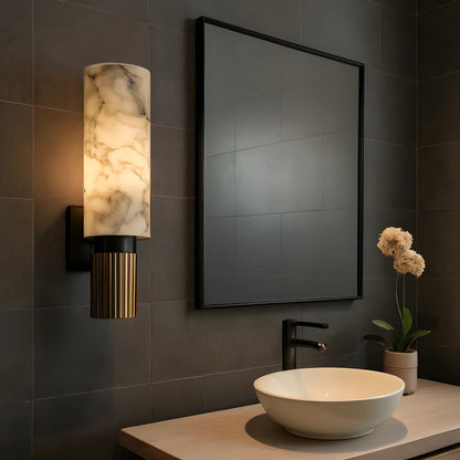 View of a chic Art Deco marble wall sconce with a gold finish and elegant geometric design