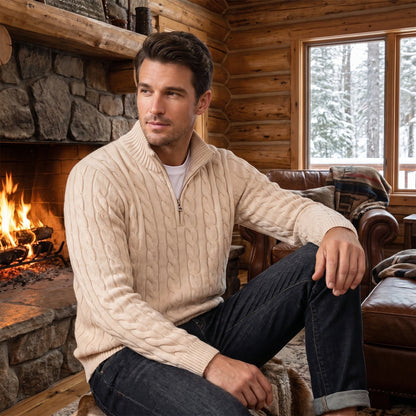 Close up view of the men's modern relaxed winter sweater showing intricate cable knit texture and detailed stitching in a rich navy color against a neutral background.