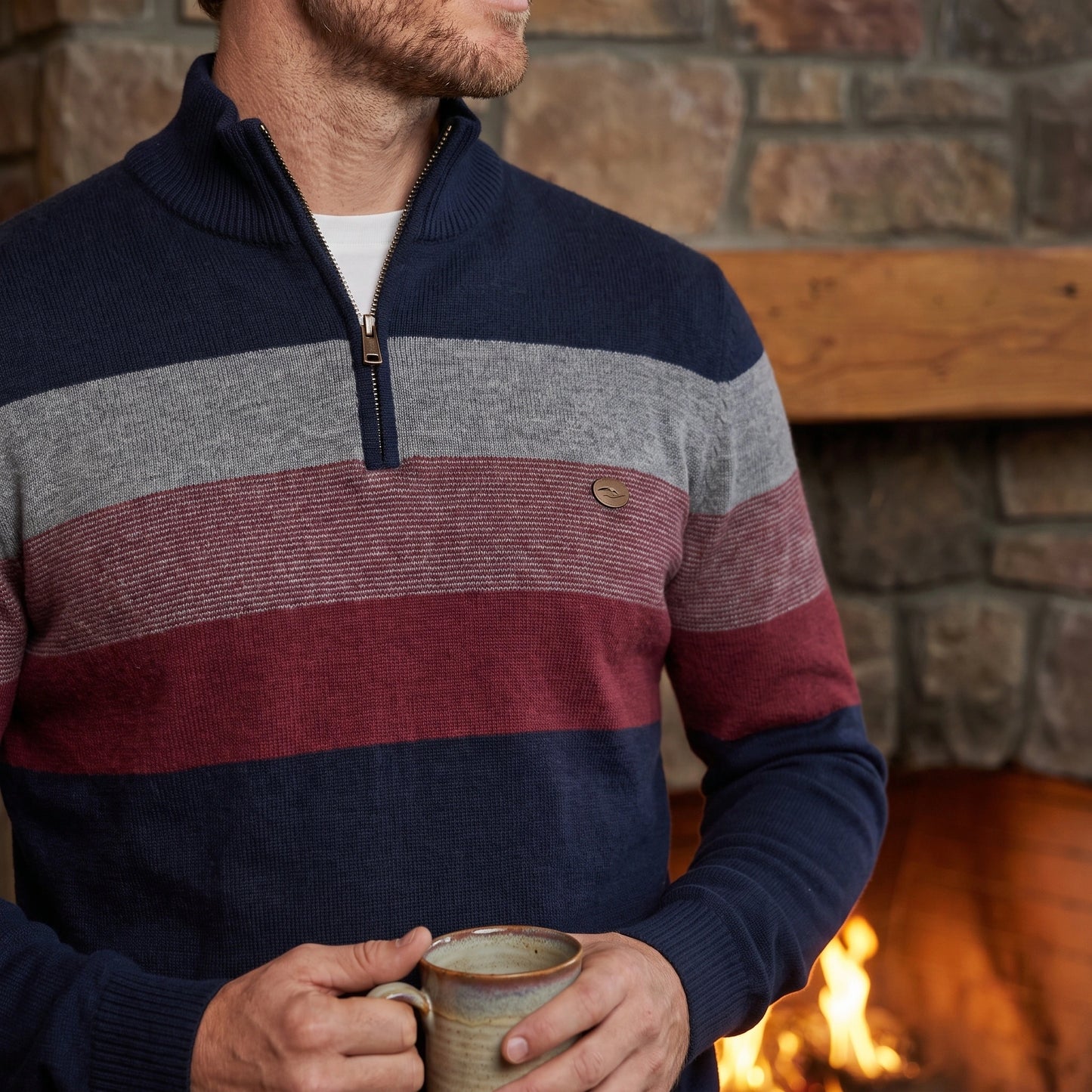 A model showcases a men's ribbed knit quarter zip sweater in navy and white stripes, styled with casual jeans against a neutral background.