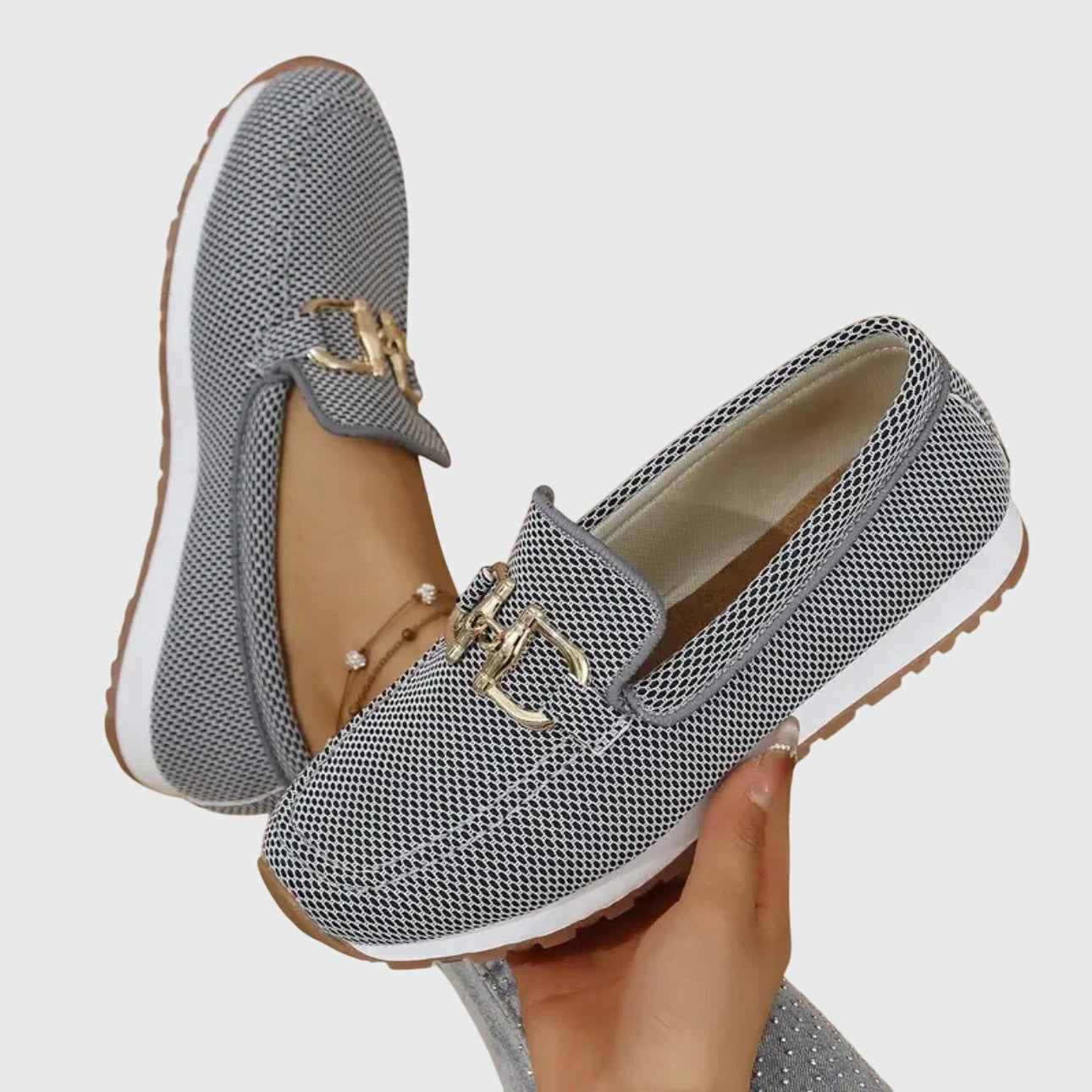 View of elegant women's loafers in soft beige leather, featuring a breathable design and subtle stitching accents