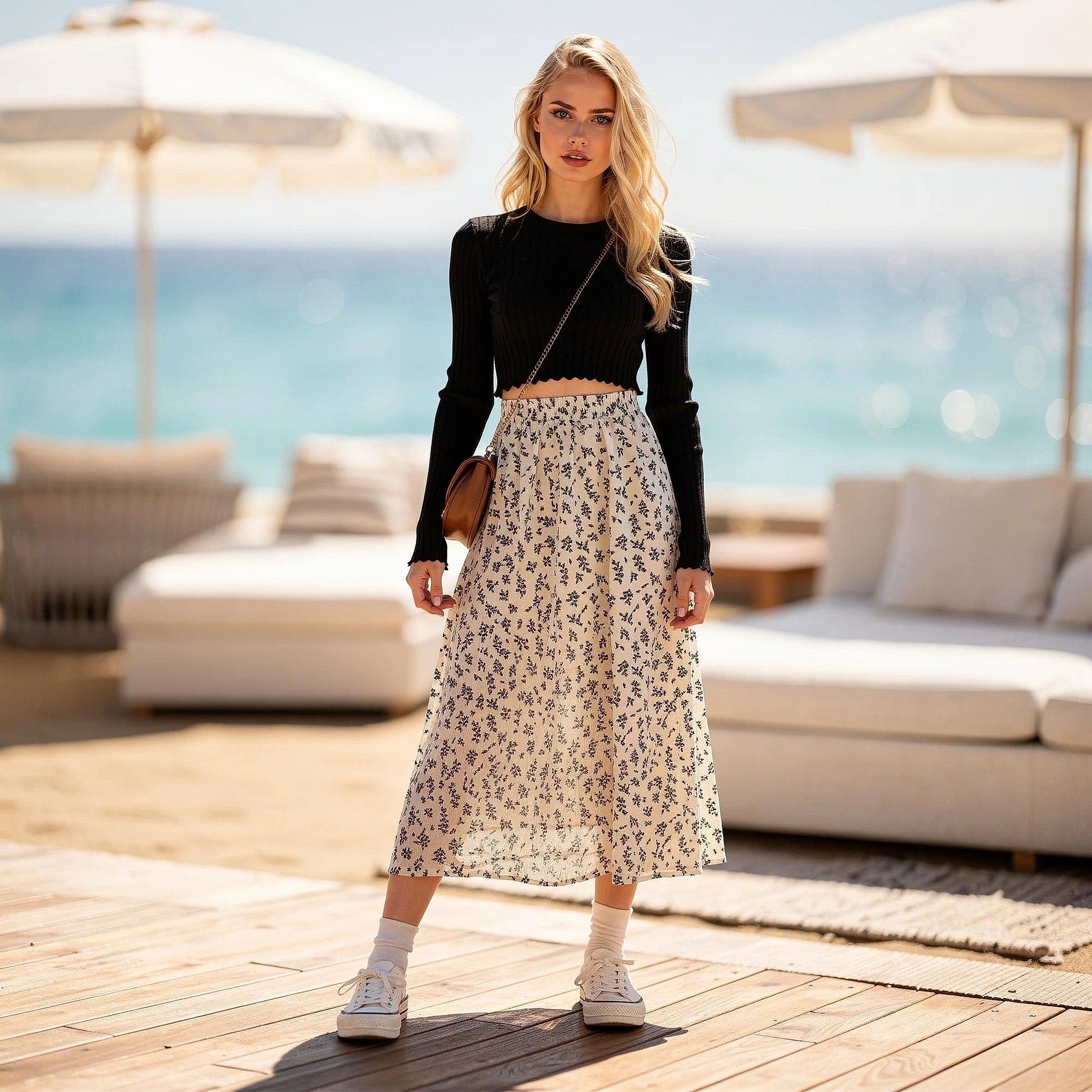 Light pink midi skirt made of flowy fabric, featuring a delicate floral pattern, detailed view showcasing the waistband and hem
