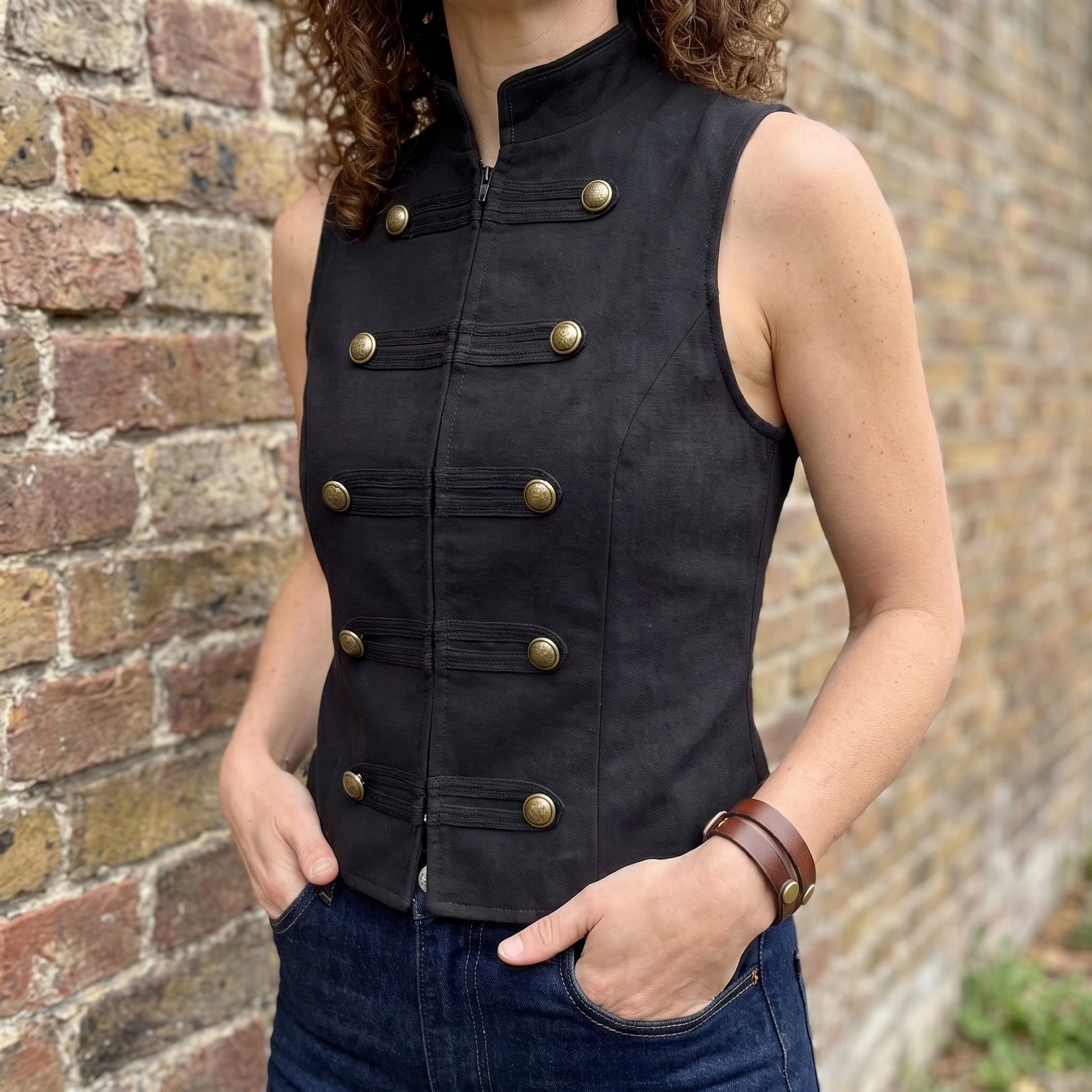 Back view of a model wearing the Womens Sleek Spring Top in Black, showing the tailored fit and construction details against a neutral background.