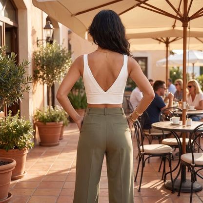 Back view of a model showing the Womens Supportive Cropped Top in a soft charcoal color, showing its construction and design against a neutral background.