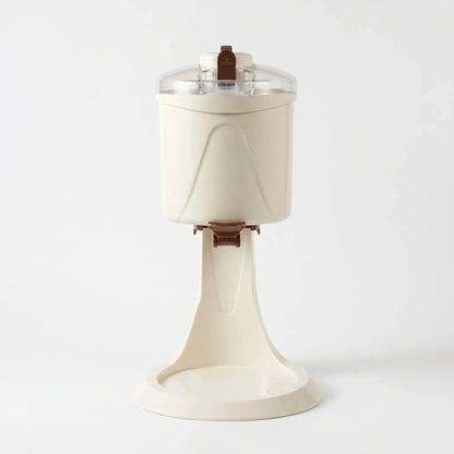 Angle view showcasing the sleek design, power cord placement, and ventilation vents of the compact ice cream maker