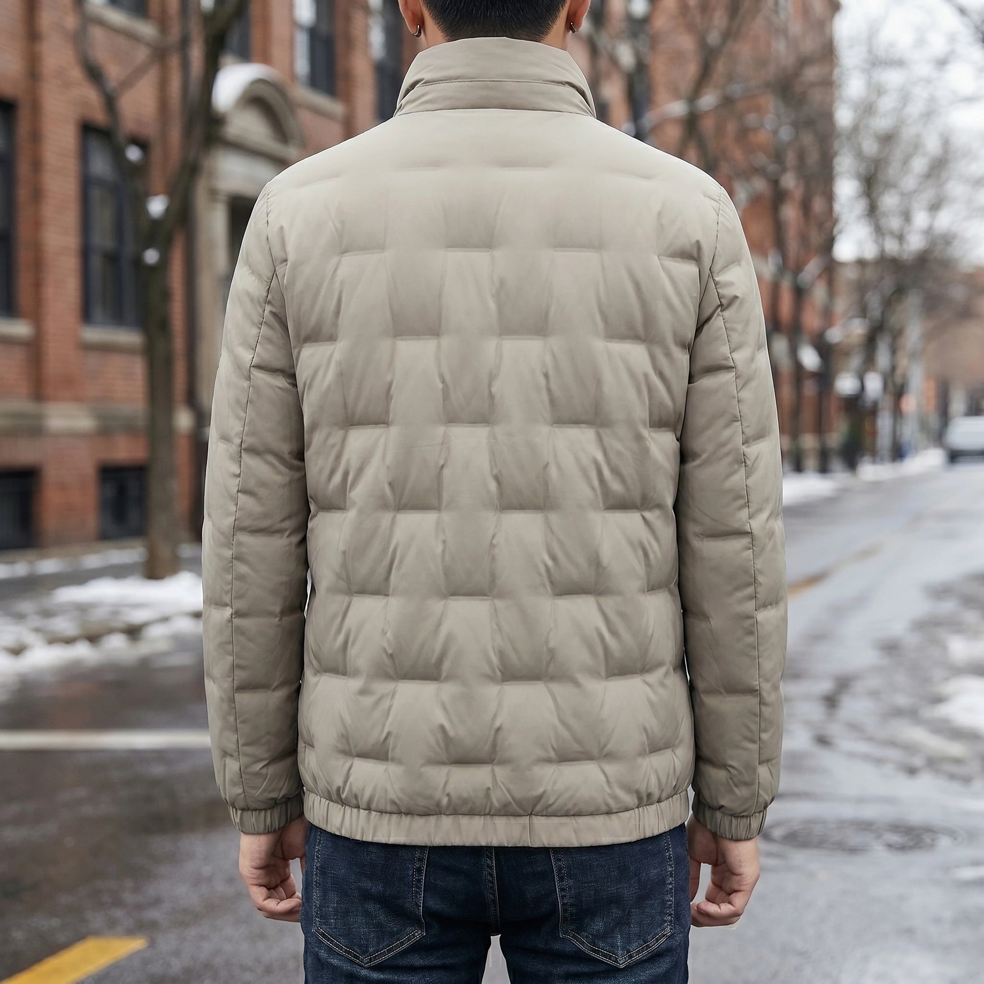 Close up view of the mens lightweight durable winter jacket showing its high quality fabric, intricate stitching, and design details against a neutral background.