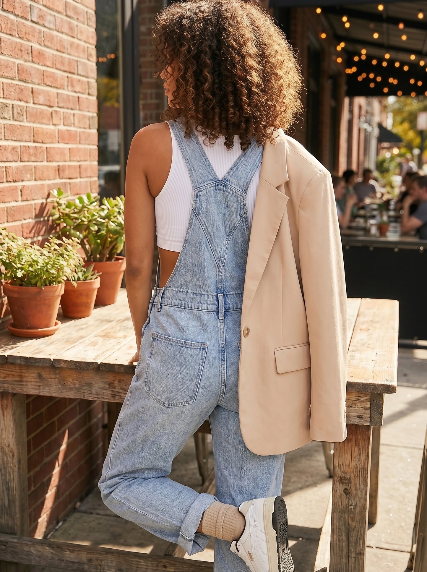 Close up view of the Women's Relaxed Effortless Jumpsuit showing its soft fabric, precise stitching, and high quality details against a neutral background.