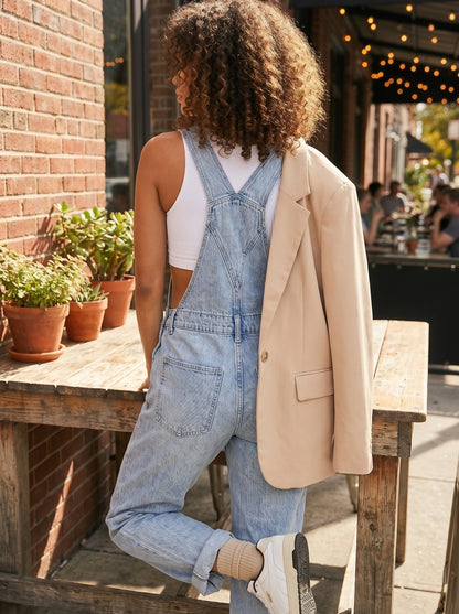 Close up view of the Women's Relaxed Effortless Jumpsuit showing its soft fabric, precise stitching, and high quality details against a neutral background.