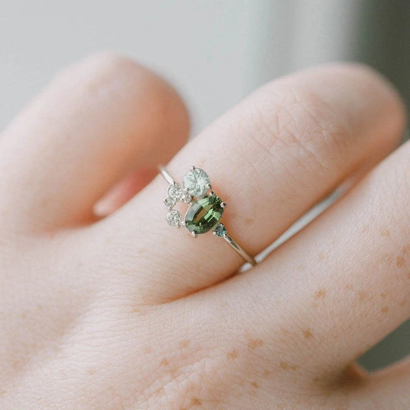 View of an elegant women's ring featuring a delicate design with a vibrant peridot gemstone set in a polished metal band