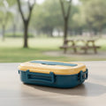 View of a contemporary stainless steel bento lunch box with multiple compartments and a sleek design, ideal for on the go meals