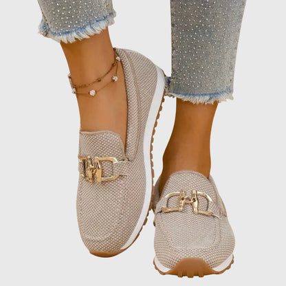 View of elegant women's loafers in soft beige leather with a breathable design and subtle stitching details